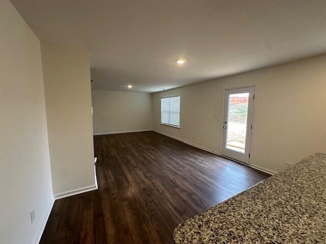 empty room with dark wood-type flooring