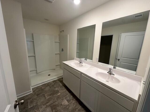 bathroom featuring vanity and walk in shower