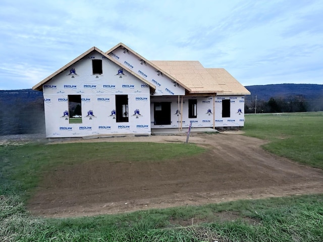 property in mid-construction with a front lawn