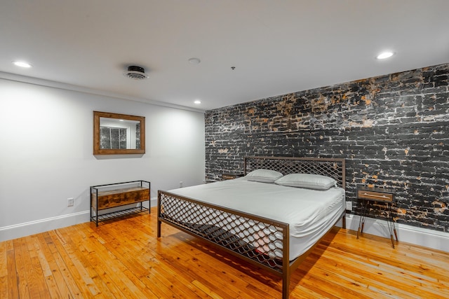 bedroom featuring baseboards, wood-type flooring, and recessed lighting