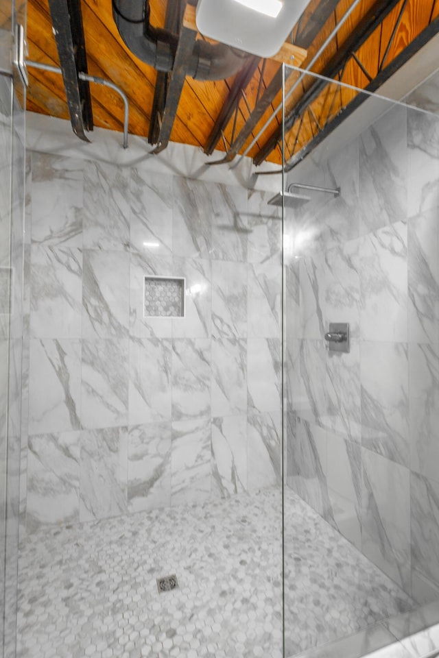 interior space featuring a marble finish shower