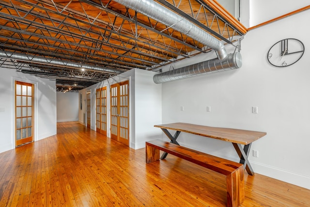 basement featuring wood-type flooring and baseboards