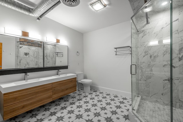 full bathroom featuring a marble finish shower, baseboards, visible vents, toilet, and a sink