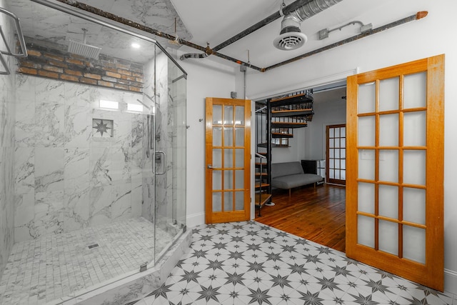 full bathroom with french doors, a marble finish shower, and tile patterned floors