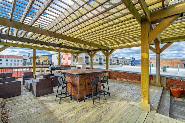 deck featuring a view of city, a pergola, outdoor dry bar, and an outdoor hangout area