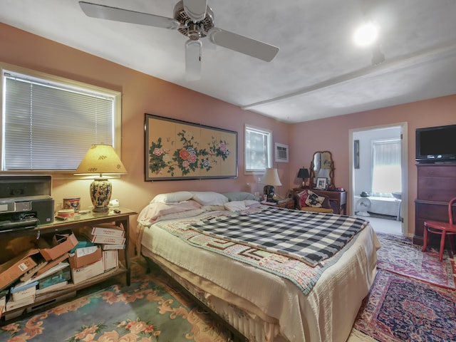 bedroom featuring ensuite bathroom and ceiling fan