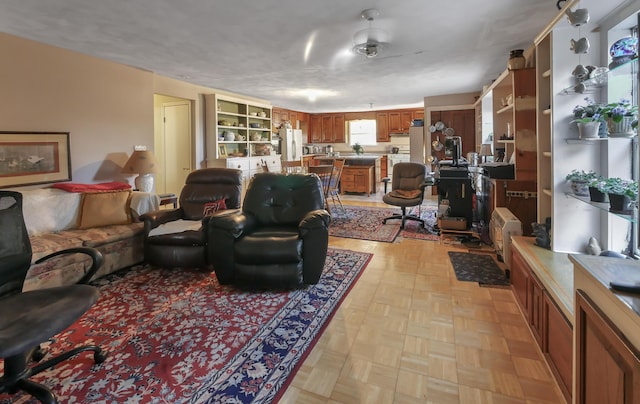 living room featuring ceiling fan and light parquet flooring