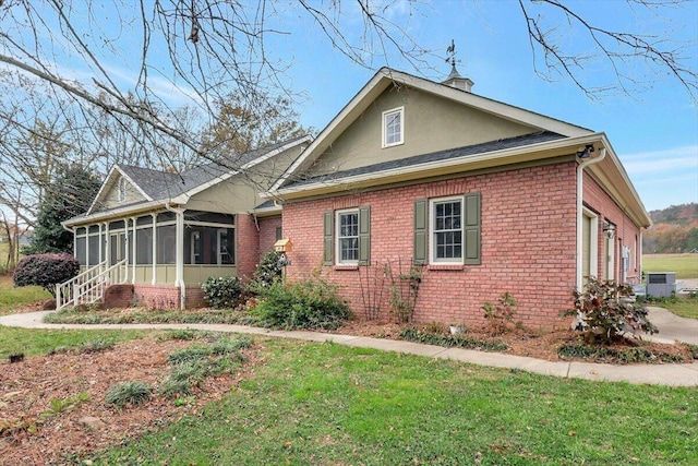 view of front of home with a front lawn and a sunroom