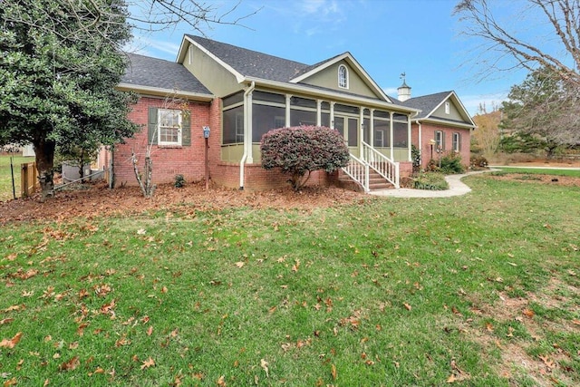 exterior space with a sunroom and a front lawn