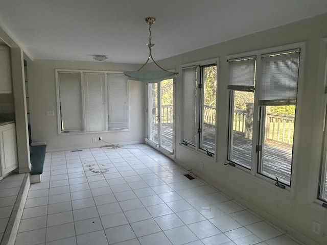 unfurnished dining area featuring light tile patterned floors