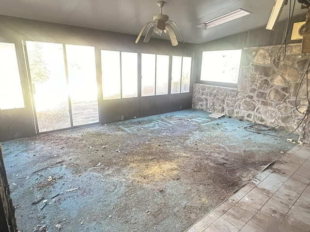 empty room with ceiling fan and lofted ceiling