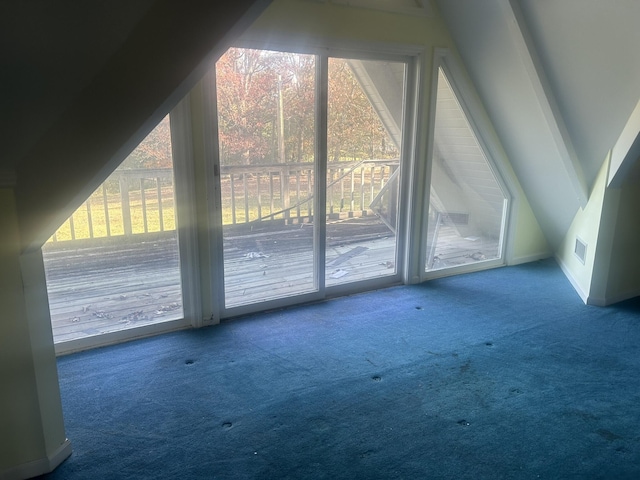 bonus room with carpet flooring, plenty of natural light, and lofted ceiling