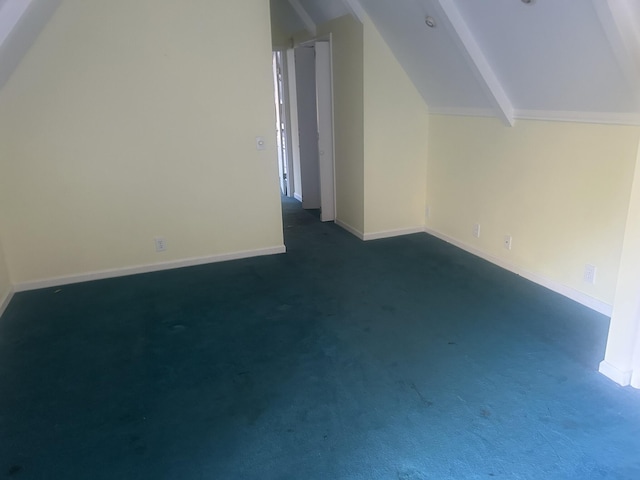 bonus room with lofted ceiling with beams and dark colored carpet