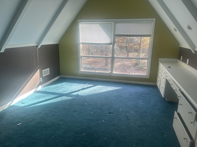 bonus room featuring dark carpet and vaulted ceiling