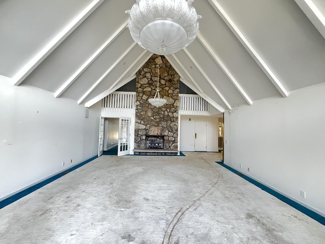 unfurnished living room featuring a fireplace, high vaulted ceiling, and beamed ceiling