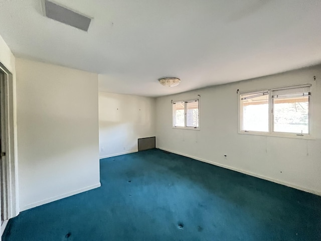 unfurnished room featuring dark colored carpet