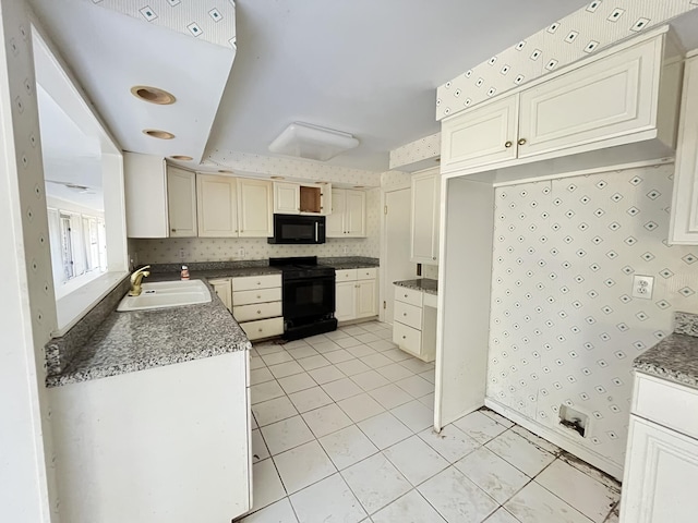 kitchen featuring sink, light tile patterned flooring, and black appliances