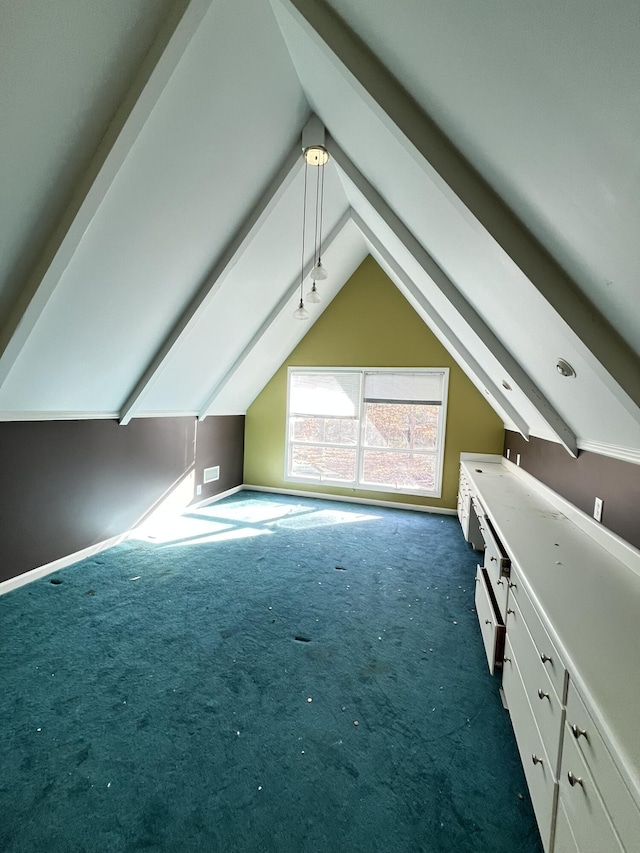 additional living space with dark carpet and vaulted ceiling