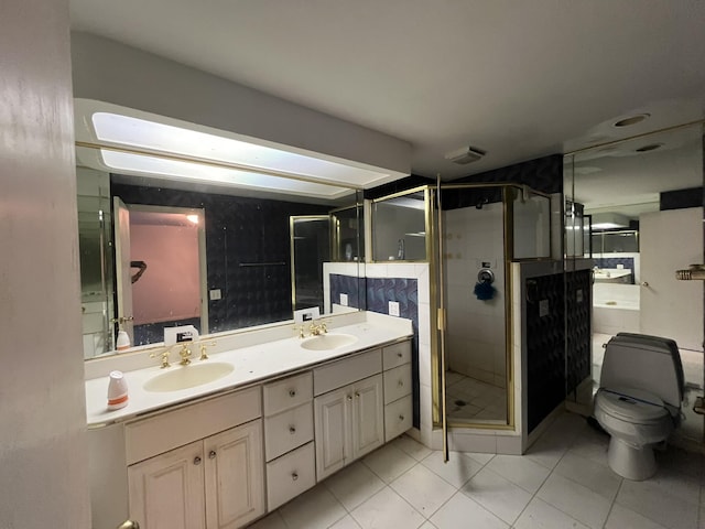 bathroom featuring tile patterned flooring, vanity, toilet, and walk in shower