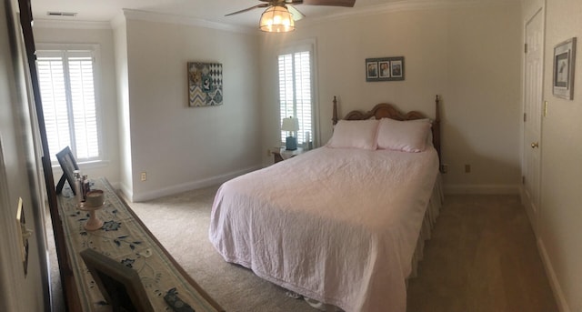 carpeted bedroom featuring multiple windows, ceiling fan, and ornamental molding