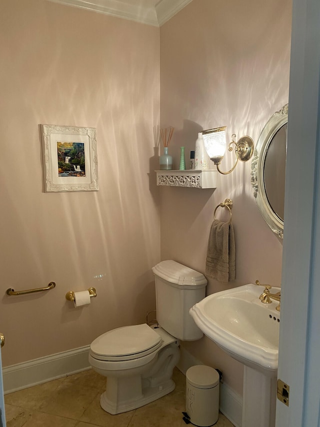 bathroom with tile patterned flooring, toilet, and crown molding