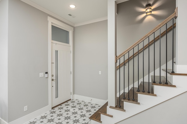 entryway featuring crown molding