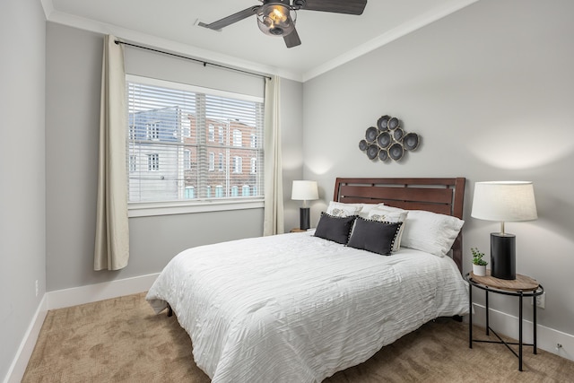 carpeted bedroom featuring ornamental molding and ceiling fan