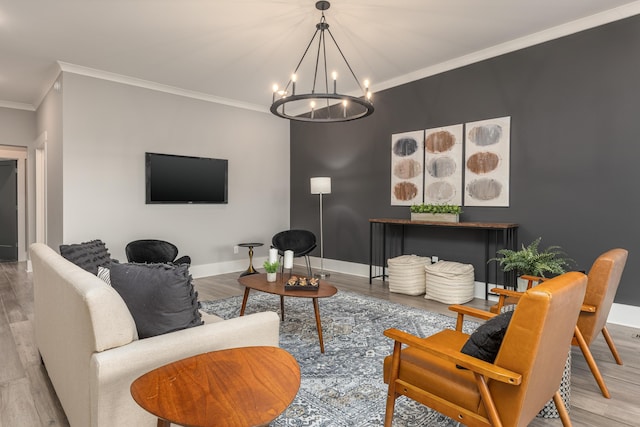 living room with ornamental molding, light wood-type flooring, and a chandelier