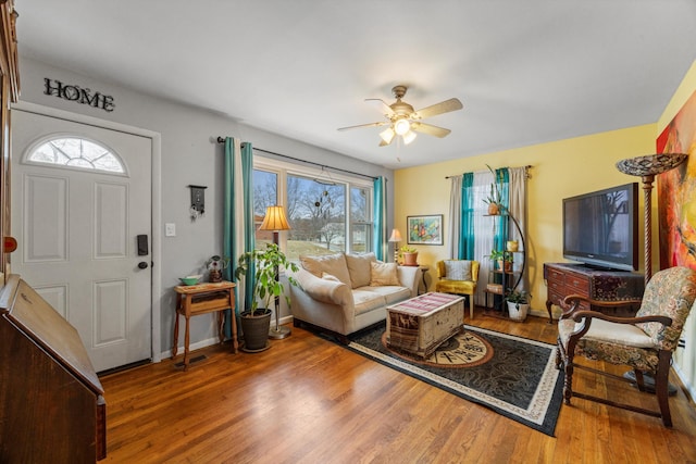 living room with ceiling fan and wood-type flooring