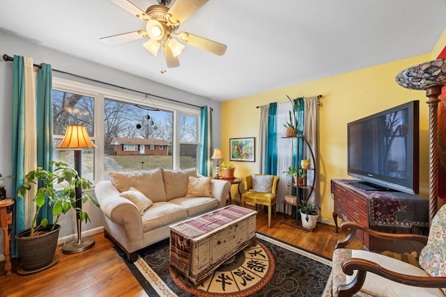 living room featuring ceiling fan and dark wood-type flooring