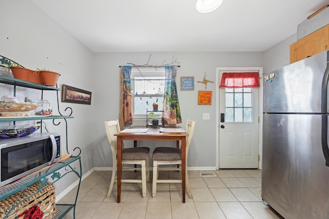 dining area with light tile patterned flooring