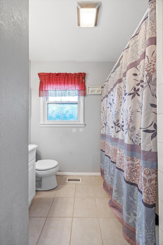 bathroom featuring tile patterned floors, vanity, and toilet