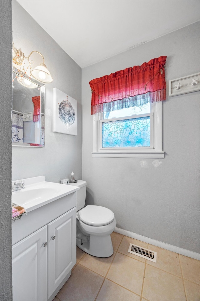 bathroom featuring tile patterned flooring, vanity, and toilet