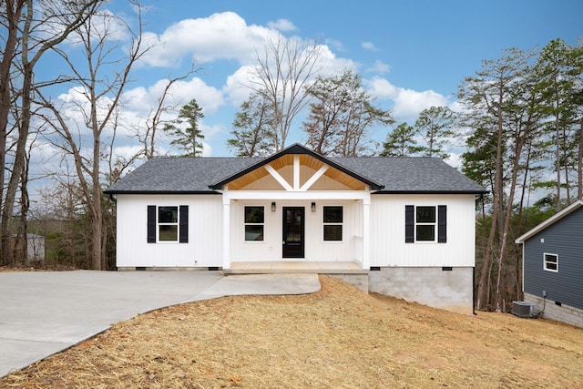 view of front of home with covered porch and central AC unit