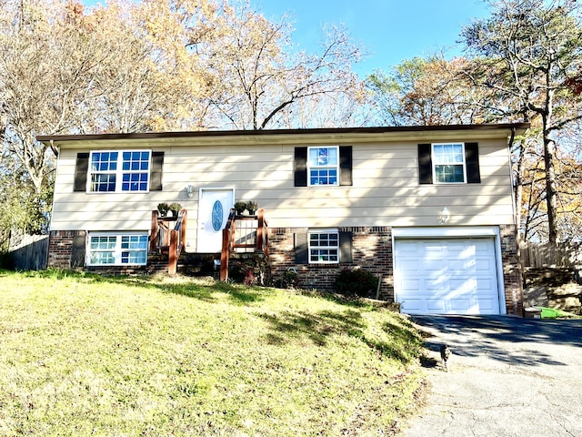 raised ranch with a garage and a front yard