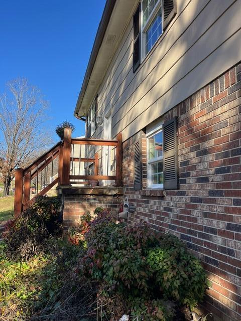 view of side of home featuring a wooden deck