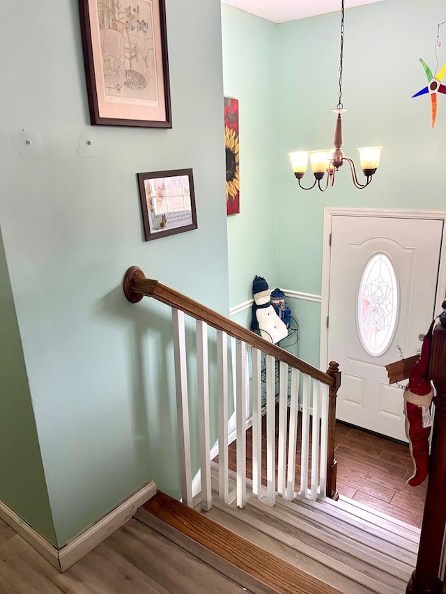 entrance foyer featuring hardwood / wood-style flooring and a chandelier