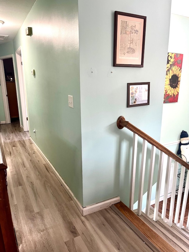 corridor with light hardwood / wood-style flooring