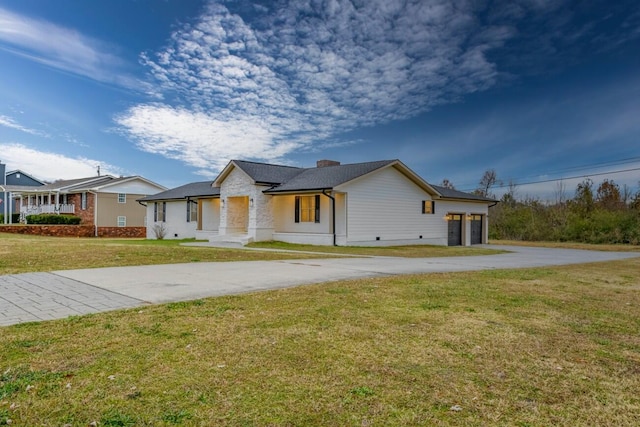 view of front of property with a garage and a front lawn