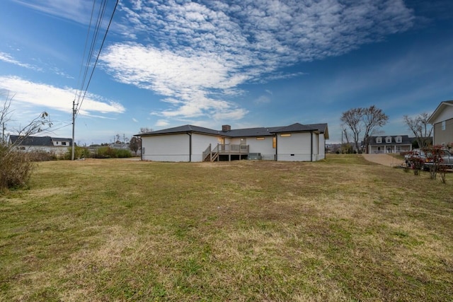 rear view of property featuring a lawn