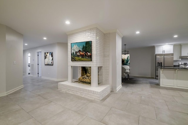 unfurnished living room featuring a fireplace and light tile patterned floors