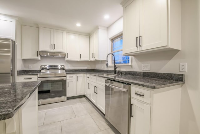 kitchen with light tile patterned floors, white cabinetry, sink, and appliances with stainless steel finishes