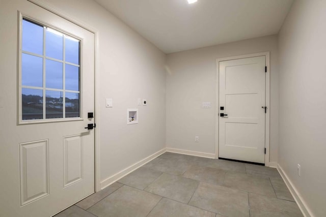 clothes washing area featuring hookup for an electric dryer, washer hookup, and light tile patterned floors