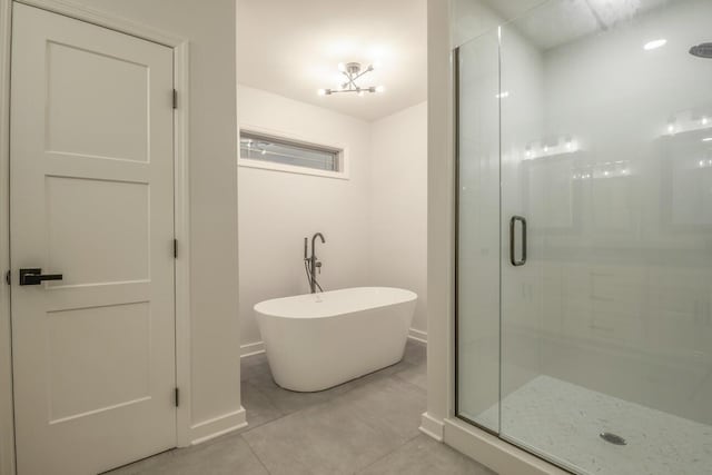 bathroom with tile patterned floors and separate shower and tub