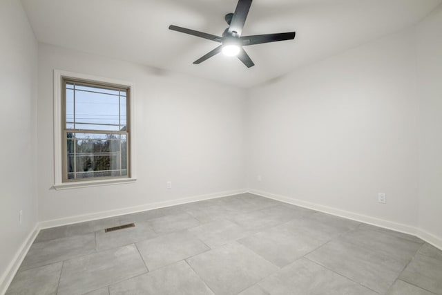 unfurnished room with ceiling fan and light tile patterned floors