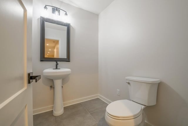 bathroom with tile patterned floors and toilet