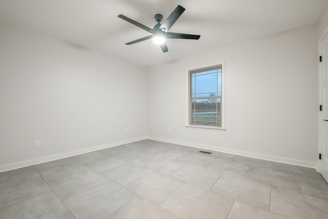 unfurnished room featuring ceiling fan and light tile patterned floors