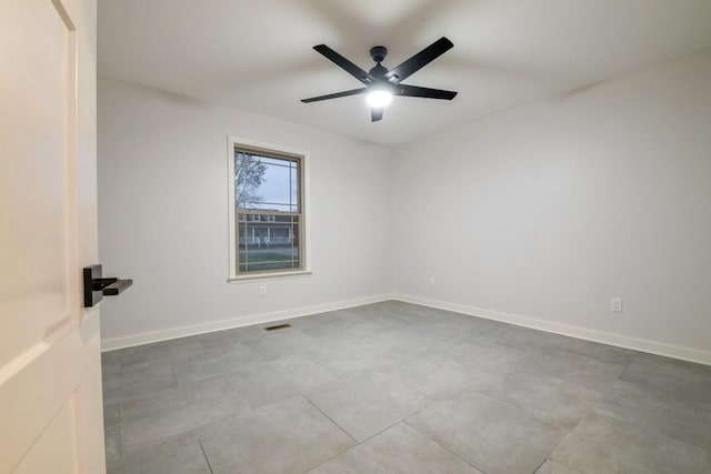 tiled empty room with ceiling fan