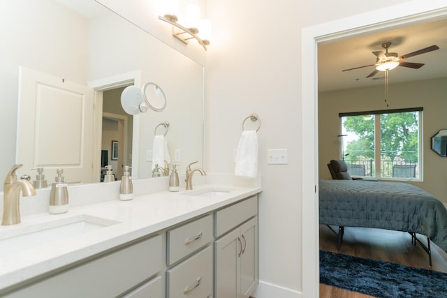 bathroom featuring wood-type flooring, vanity, and ceiling fan