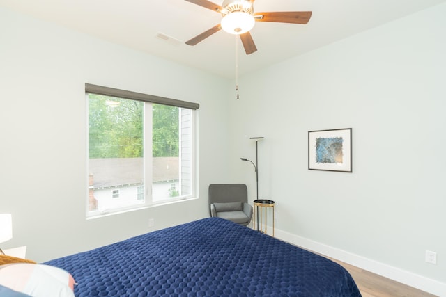 bedroom with ceiling fan and wood-type flooring